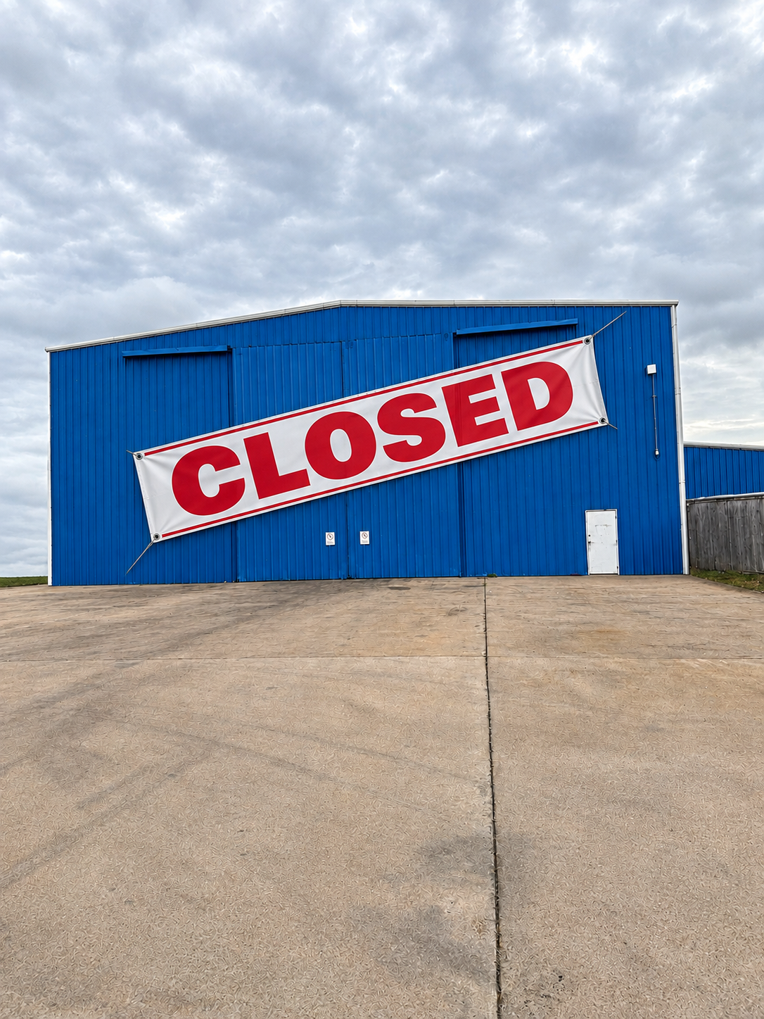 A CLOSED banner hung across the blue front of the Melvin's Lakeside Services shop